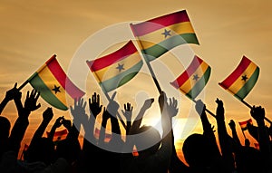 Silhouettes of People Holding Flag of Ghana