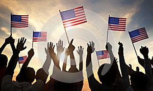 Silhouettes of People Holding the Flag of USA