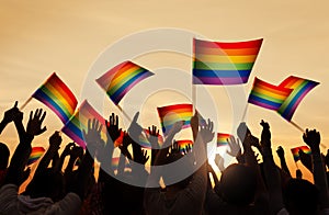 Silhouettes of People Holding Gay Pride Symbol FLag