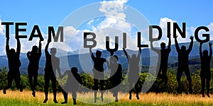 Silhouettes of people holding letters with TEAM BUILDING photo