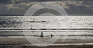 Silhouettes of people on Irish beach