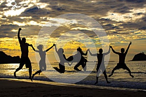 Silhouettes of people jumping