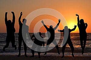 Silhouettes of people jumping