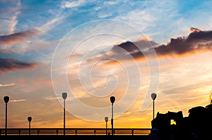 Silhouettes of people making photos of sunset in Paris