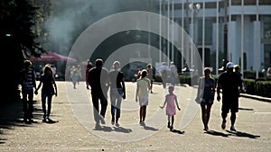 Silhouettes of people walking in park. Street food festival at exhibition center