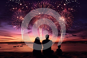 Silhouettes of people watching fireworks on a