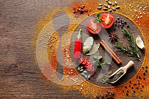 Silhouettes of plate with spoon made of spices and different ingredients on wooden table, flat lay. Space for text