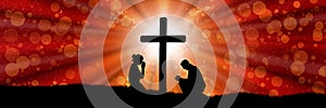 Silhouettes of praying woman and an under the cross in red color