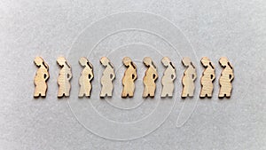 Silhouettes of pregnant women on a gray background.