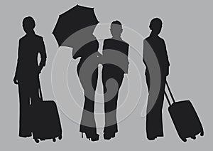 Silhouettes of pretty women group pose holding umbrella and suitcase prepare go to travel on grey colour background.