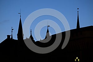 Silhouettes of roofs and spires of old town Riga houses at night