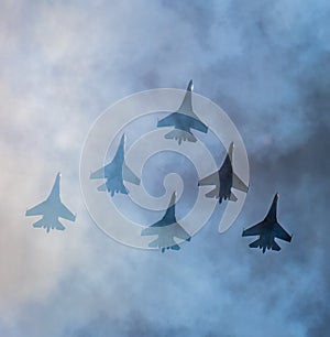 Silhouettes of russian fighter aircrafts SU-27 in the sky