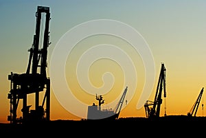 Silhouettes of shipyard cranes