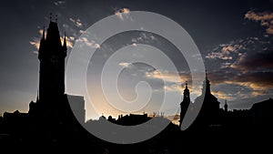 Silhouettes shot of astronomical clock tower and dome of St. Nicholas church