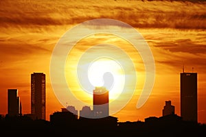 Silhouettes of skyscrapers of Istanbul against the sunset sky.