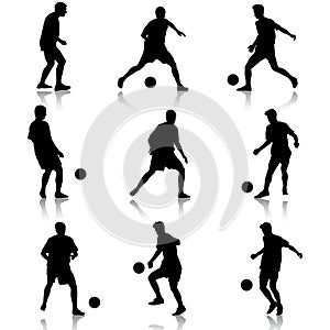 Silhouettes of soccer players with the ball.