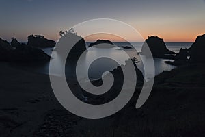 Silhouettes of stones and rocks in Pacific Northwest coastline