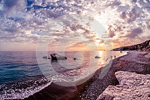 Silhouettes at sunset near Petra tou Romiou. Paphos District, Cyprus