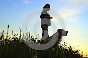 Silhouettes Of A Teenage Girl Walking With Her Pet.