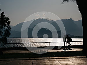 Silhouettes of teenages sitting on the railings