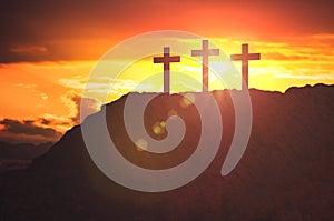 Silhouettes of three crosses at sunset on hill. Religion and christianity concept photo