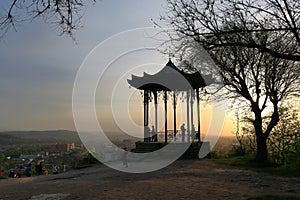 Silhouettes of tourists and a Chinese Gazebo at sunset. Pyatigorsk