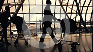 Silhouettes of travellers in airport