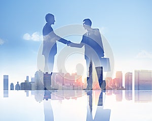 Silhouettes of Two Businessmen Having a Handshake