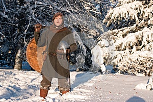 Silhouettes of two medieval warriors in the winter forest