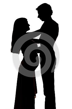 Silhouettes of two people men and a pregnant woman