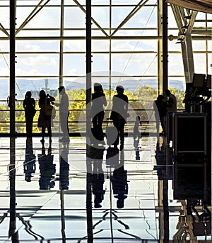 Silhouettes of unrecognizable traveling people at the airpor photo