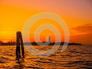 silhouettes of Venice at sunset , view from water