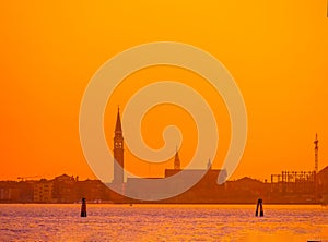 silhouettes of Venice at sunset , view from water