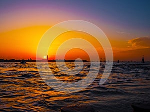 silhouettes of Venice at sunset , view from water