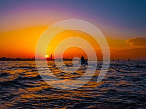 silhouettes of Venice at sunset , view from water