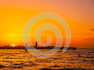 silhouettes of Venice at sunset , view from water