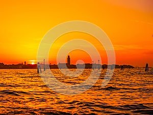 silhouettes of Venice at sunset , view from water