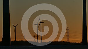 Silhouettes of Wind Turbines Against Sunset Sky