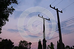 Silhouettes of wires and electric post