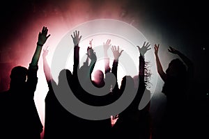 Silhouettes of young people dancing in club. Disco and party concept