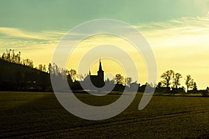 Silhouettte of catholic church in small village, Czech republic