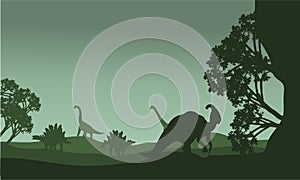 Silhouettte of parasaurolophus and stegosaurus