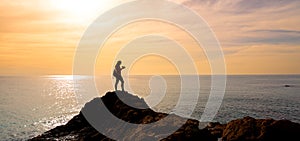 Silhouettte of woman photographer taking photo on sunset