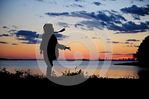 Silhouhette of a child girl walking in the sunset