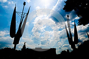 Silhoutte of Buckingham Palace under a cloudy but sunny sky