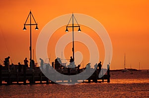 Silhoutte of fishermen at sunset or twilight photo