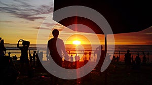 Silhoutte people at beach againts sky during sunset