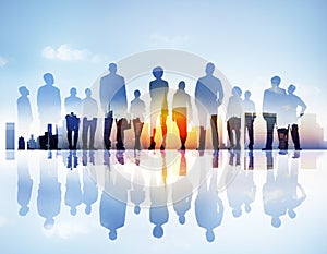 Silhouttes of Business People Looking Up in a Cityscape