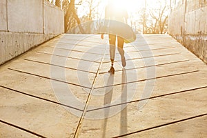 Silhuette of sunlit athletic disabled girl with prosthetic leg i