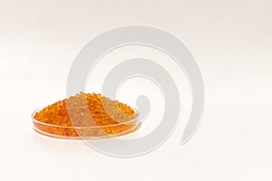 Silica gel dessicant in a glass bowl on a white background